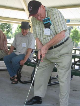 senior man practicing his putting